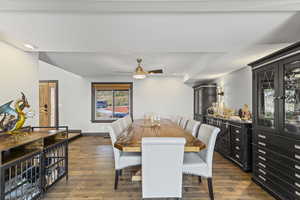 Dining space featuring dark wood-type flooring and a ceiling fan