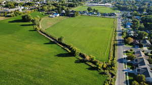 View of rural area with nearby suburban area and large plots for crops
