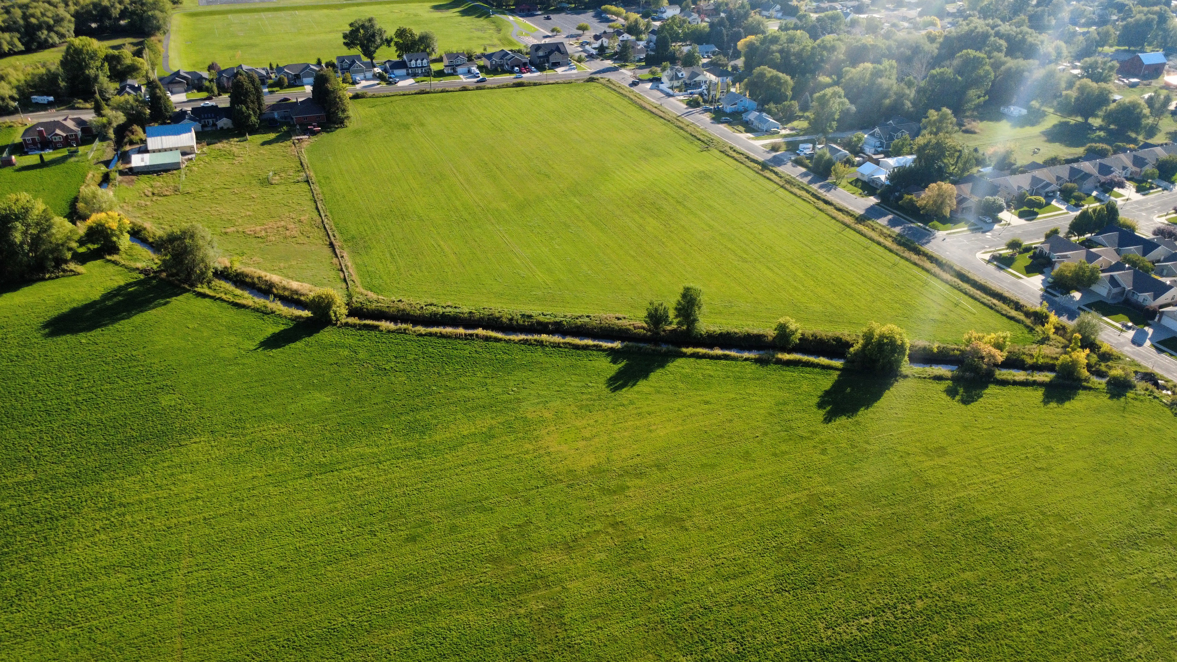 Overview of rural landscape featuring nearby suburban area