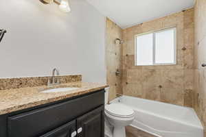 Bathroom featuring vanity, shower / tub combination, and wood finished floors