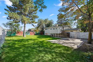 Fenced backyard featuring stairway, a patio area, and a gate