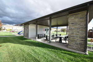 Surrounding community featuring a lawn, a patio area, and a residential view