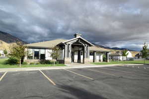 View of building exterior with a mountain view and uncovered parking