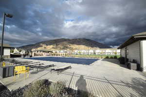 Community pool featuring a residential view, a mountain view, and a patio area