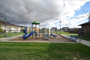 Community jungle gym with a lawn and a residential view
