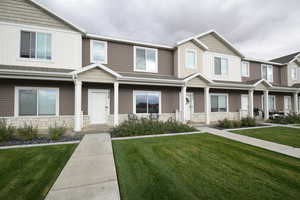 Craftsman inspired home with stone siding and a front yard