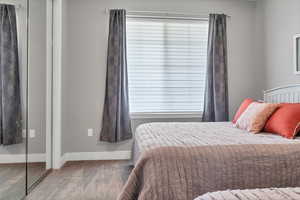 Bedroom with baseboards and wood finished floors