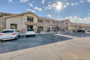 View of property featuring covered parking