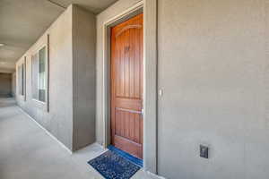 Doorway to property featuring stucco siding