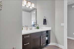 Bathroom featuring vanity and baseboards