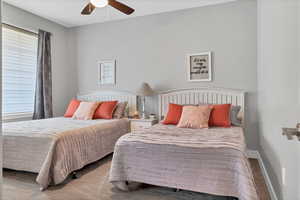 Bedroom featuring wood finished floors and ceiling fan