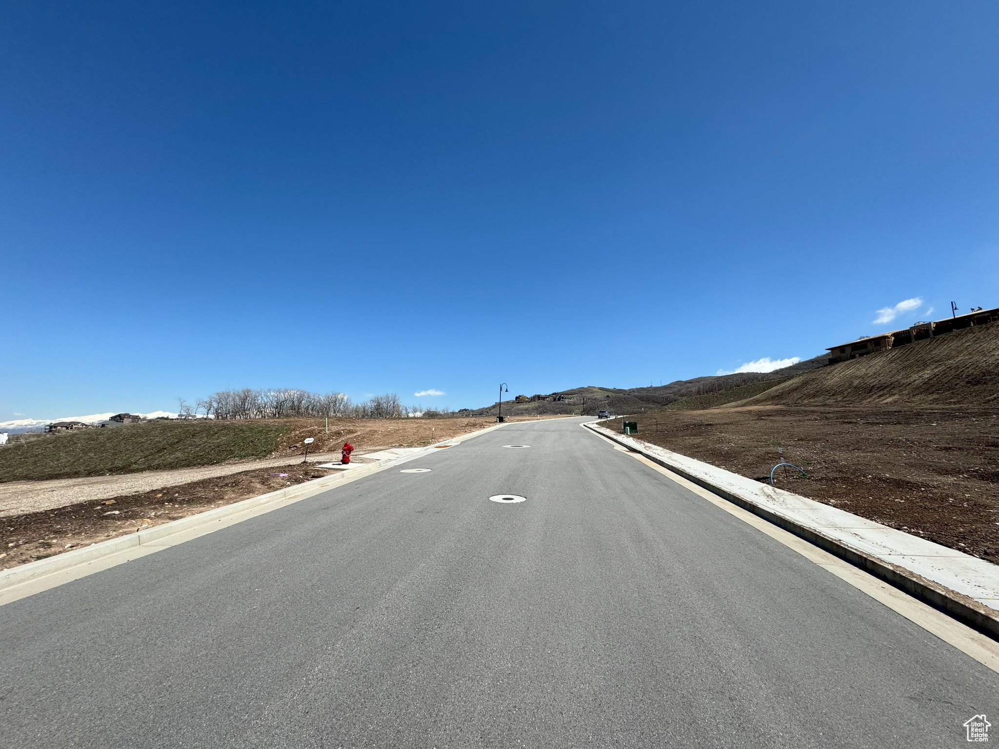 View of asphalt road with curbs