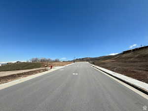 View of asphalt road with curbs