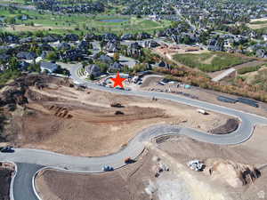 Aerial view of property's location with nearby suburban area and a large body of water