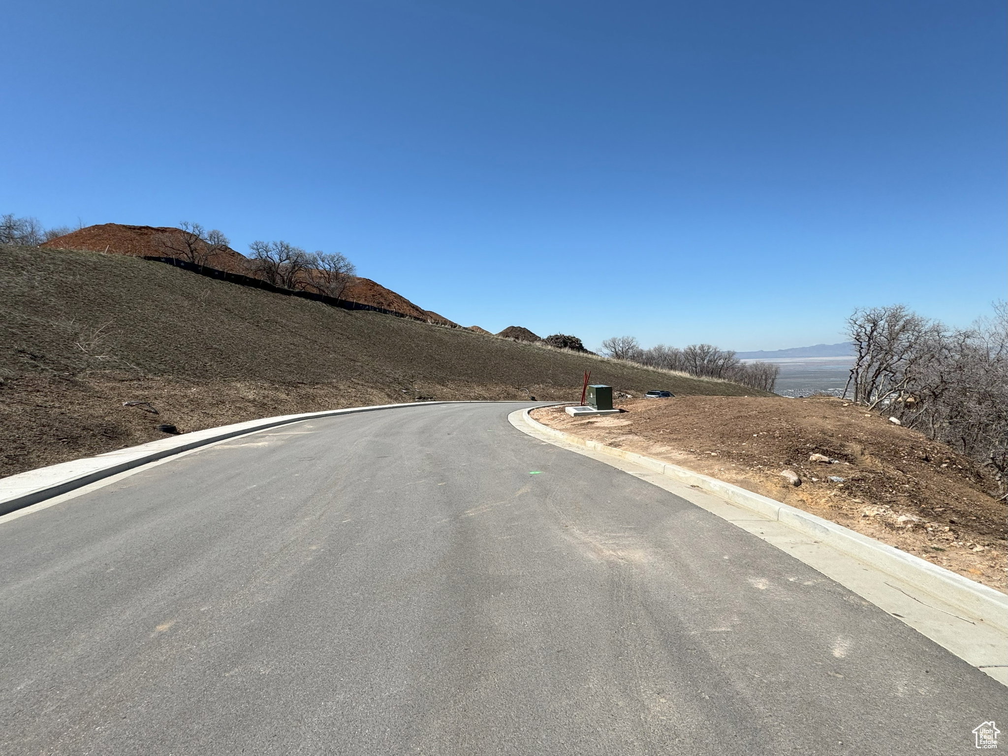 View of asphalt road with curbs