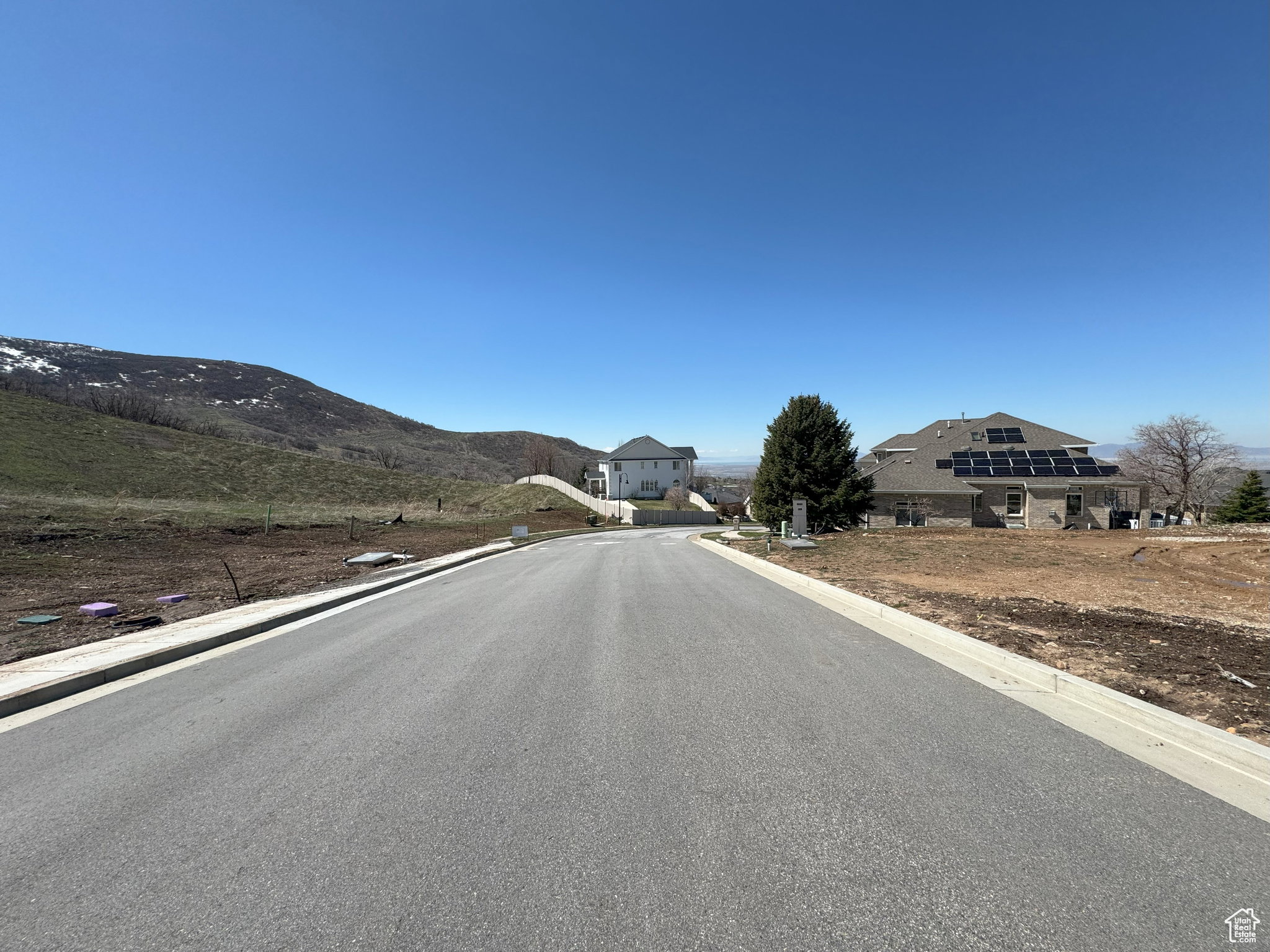 View of asphalt road with curbs