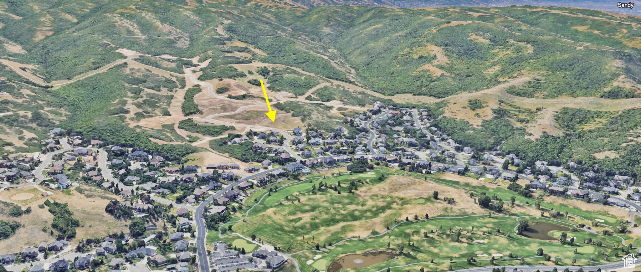 Aerial view of property and surrounding area with a local golf course