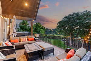 View of patio / terrace featuring outdoor lounge area and a hot tub