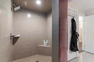Full bathroom featuring a tile shower and tile patterned floors