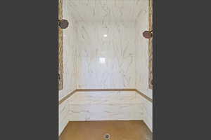 Master Bathroom view of a marble finish shower