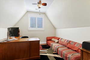 Home office with vaulted ceiling, wood finished floors, and ceiling fan