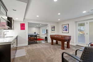 Recreation room featuring recessed lighting and light carpet