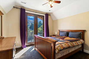 Bedroom with lofted ceiling, access to outside, dark carpet, and ceiling fan