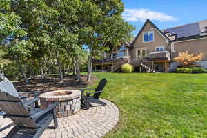 View of grassy yard with stairs, a patio area, and a wooden deck