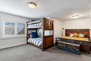 Bedroom with carpet flooring and baseboards