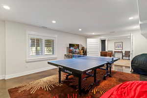 Game room with recessed lighting and concrete floors