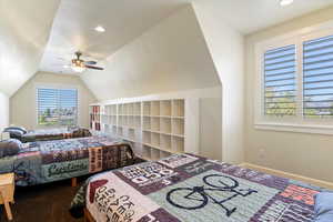 Carpeted bedroom featuring ceiling fan, lofted ceiling, and recessed lighting