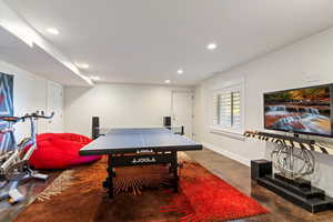 Game room with recessed lighting and concrete flooring