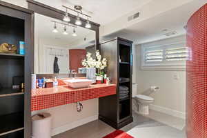 Bathroom featuring light tile patterned flooring and vanity