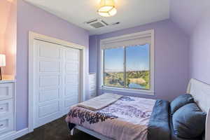 Carpeted bedroom with a closet