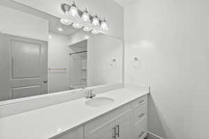 Bathroom with vanity and baseboards
