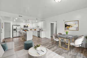 Living room with light wood-style floors and recessed lighting