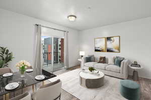 Living area with baseboards and wood finished floors