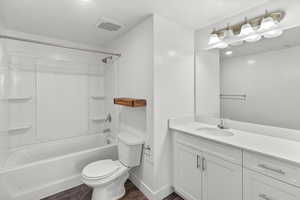 Full bathroom with  shower combination, vanity, and dark wood finished floors