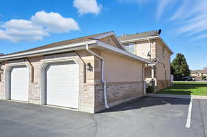 View of side of property, garage and reserved parking space