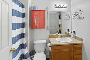Bathroom with vanity and curtained shower