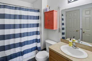 Full bathroom with vanity and a shower with curtain