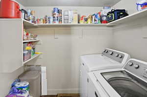 Laundry room featuring washer and dryer, storage and central vacuum