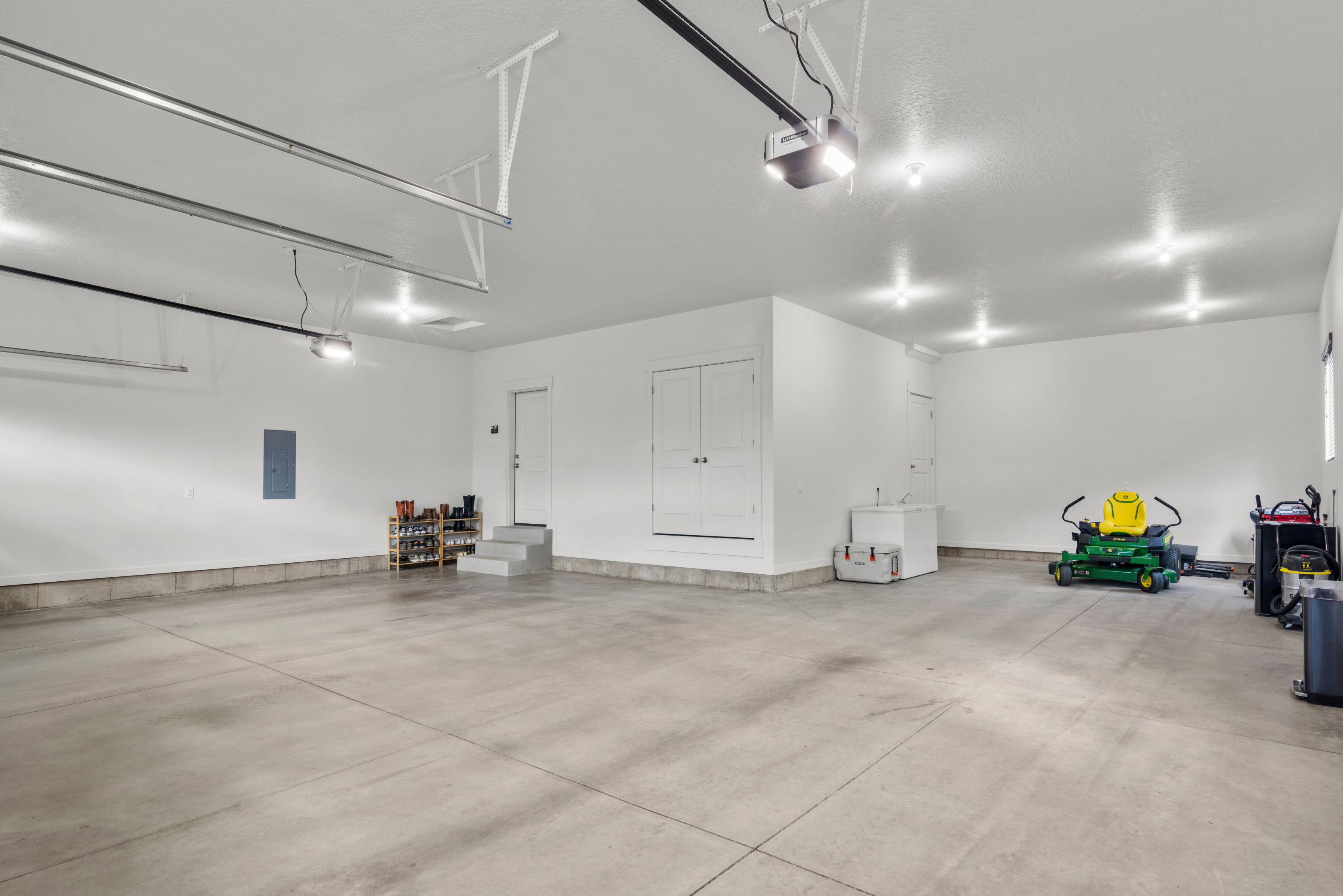 Garage with electric panel and a garage door opener