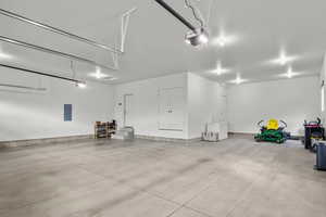 Garage with electric panel and a garage door opener