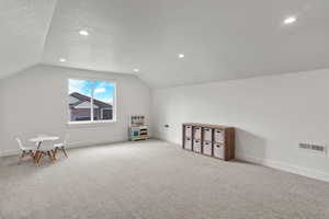 Bonus room with carpet, vaulted ceiling, a textured ceiling, and recessed lighting