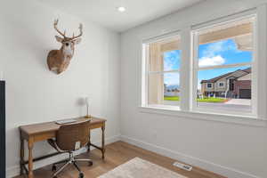 Office featuring light wood-style flooring and recessed lighting