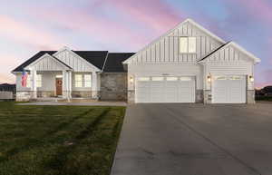 Modern inspired farmhouse featuring board and batten siding, a porch, concrete driveway, and a yard