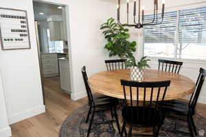 Dining room featuring light wood finished floors and a chandelier