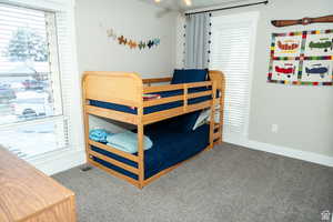 Bedroom with carpet flooring and baseboards