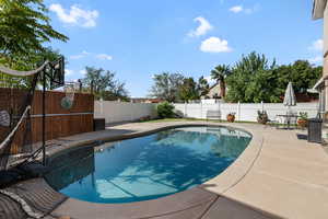 View of pool featuring a patio and a fenced backyard